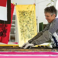 Jill screen printing texiles on the veranda of the Anchor Inn